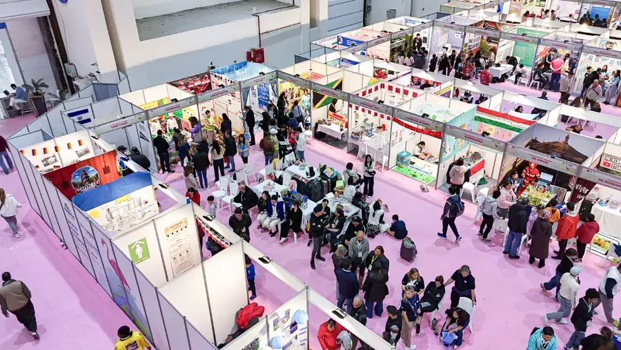 Exhibition hall with booths and visitors at a STEM education event
